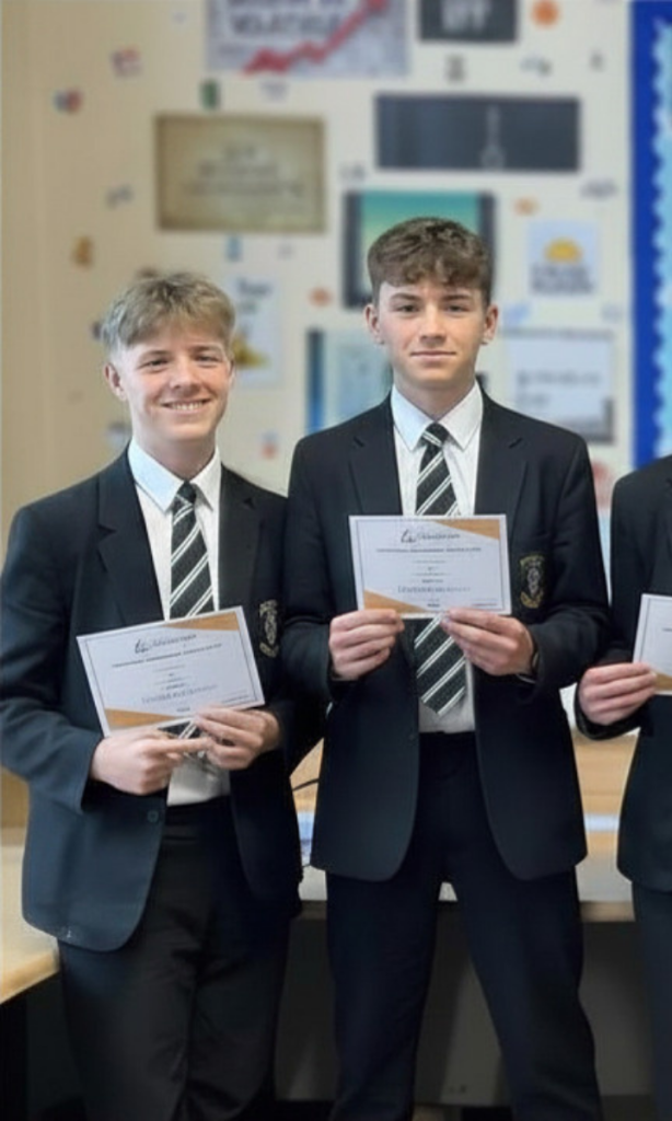 Students holding certificates of achievement