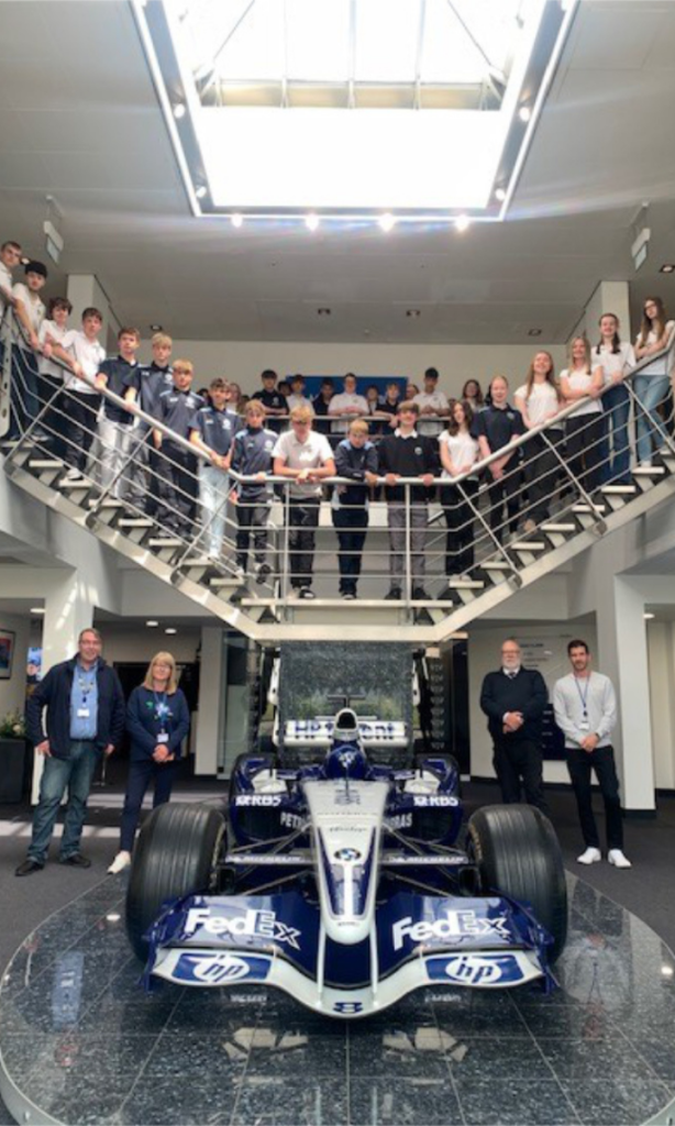 A BWM Williams F1 car surrounded by students