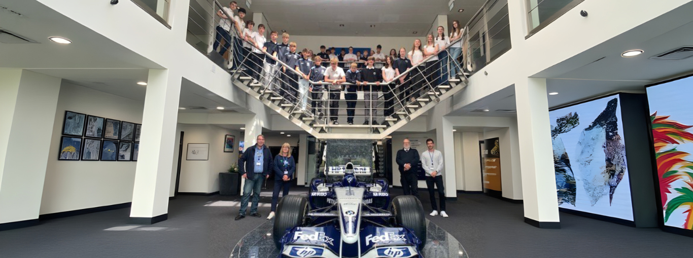 A BWM Williams F1 car surrounded by students