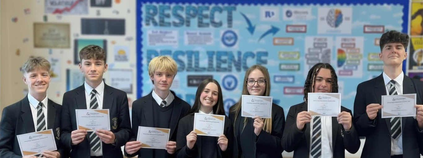 Students holding certificates of achievement
