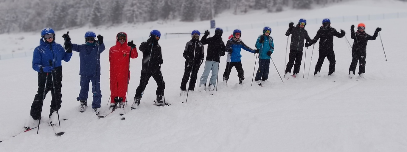 Students on a ski slope oin heavy snow conditions